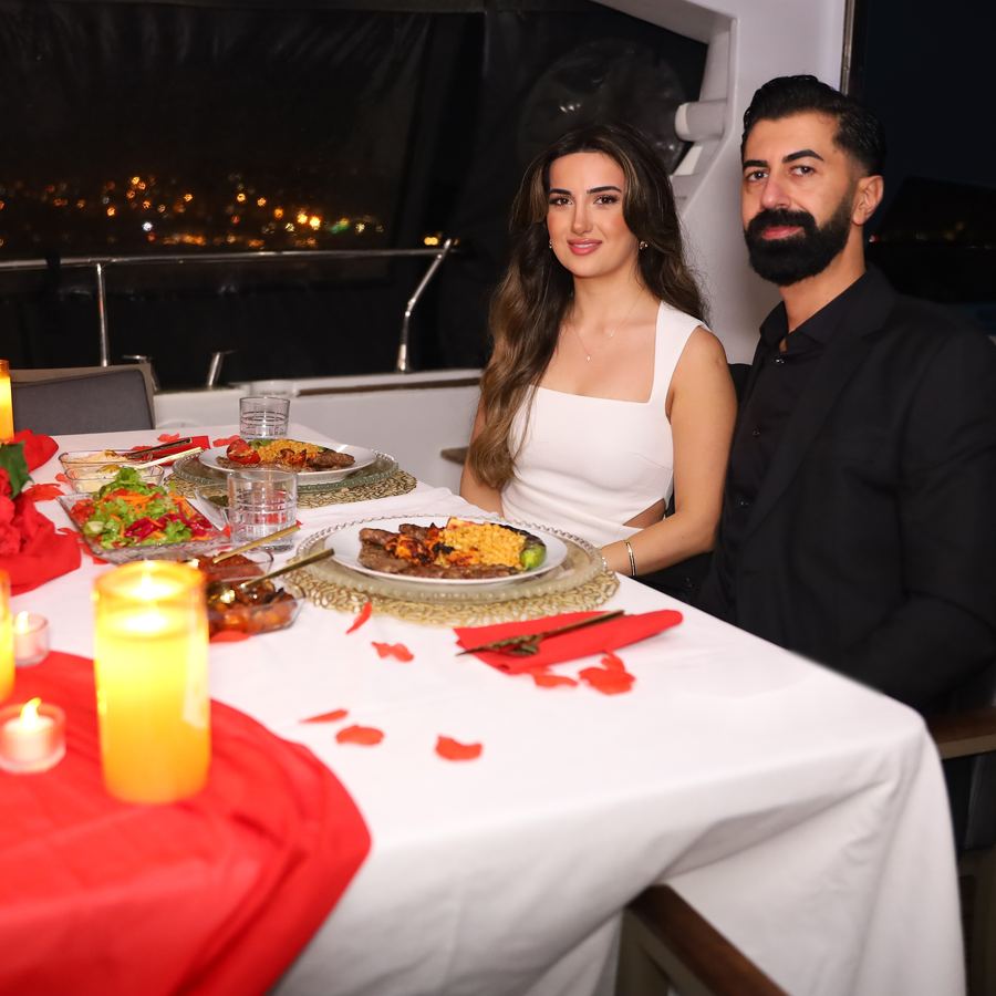 Couple having dinner on board by candlelight