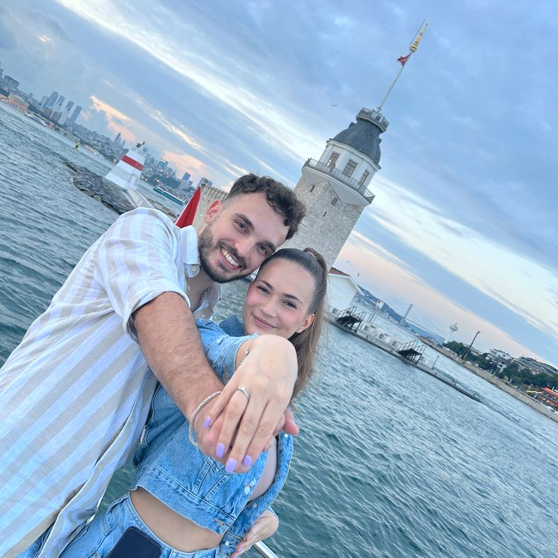 Couple showing the engagement ring in front of the Maiden's Tower