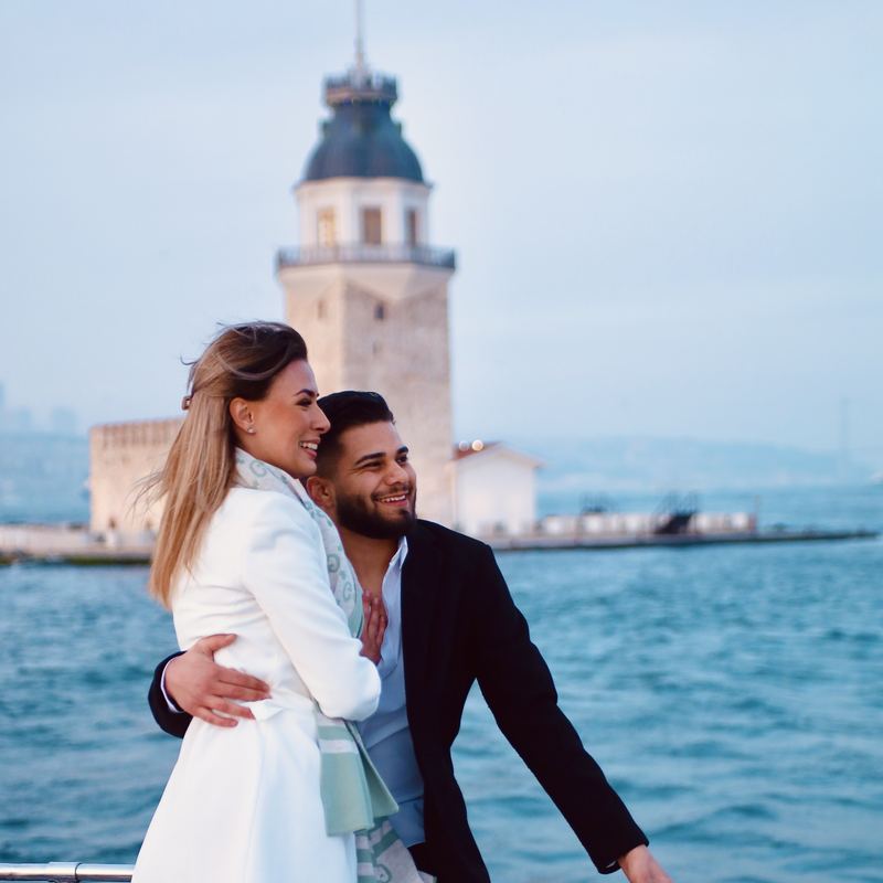 Couple on deck with the Maiden's Tower behind them by day