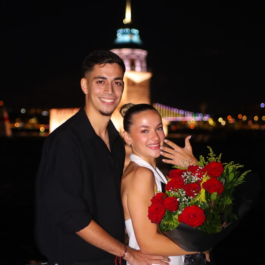 Couple with a bouquet of roses after the proposal at the Maiden's Tower in Istanbul