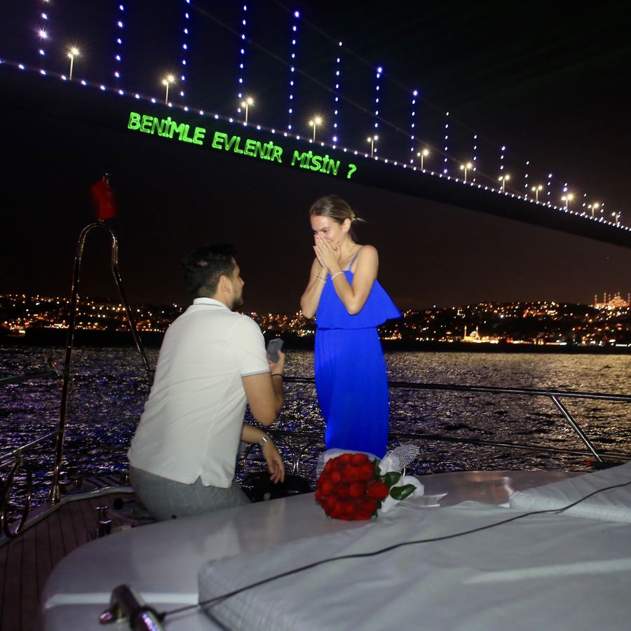 Yacht proposal with laser writing under the Bosphorus Bridge in Istanbul