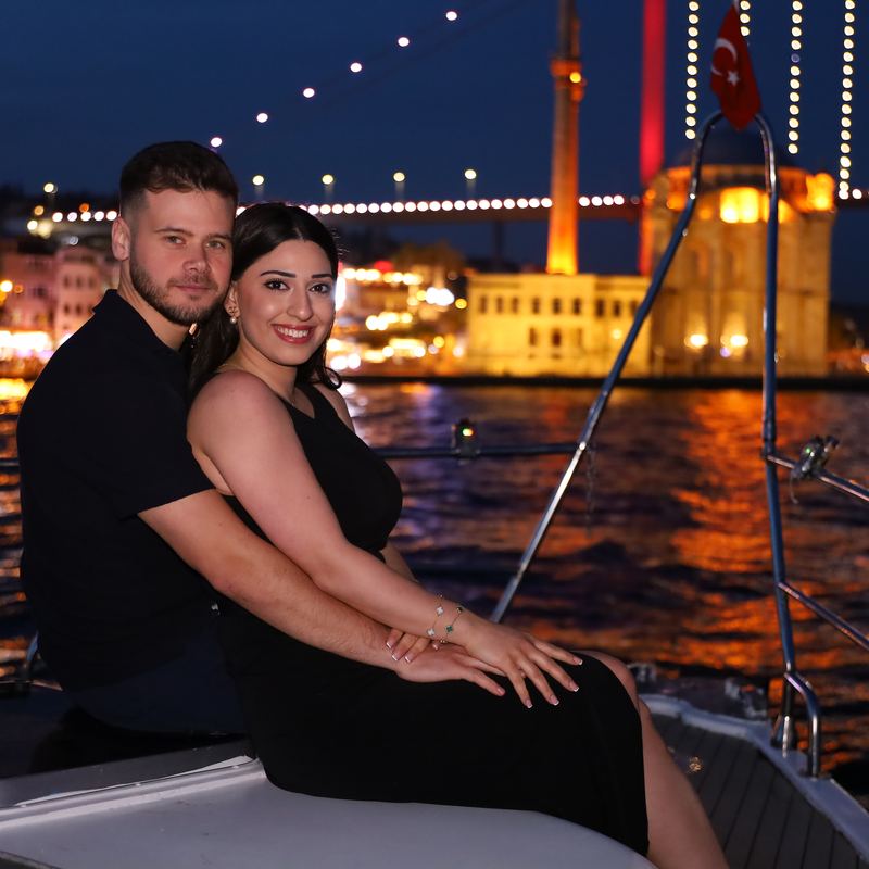 Couple on board in front of Ortaköy Mosque and the Bosphorus Bridge