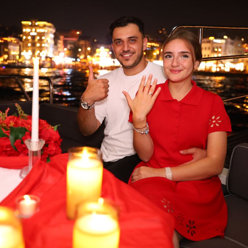 Couple showing the engagement ring at the table