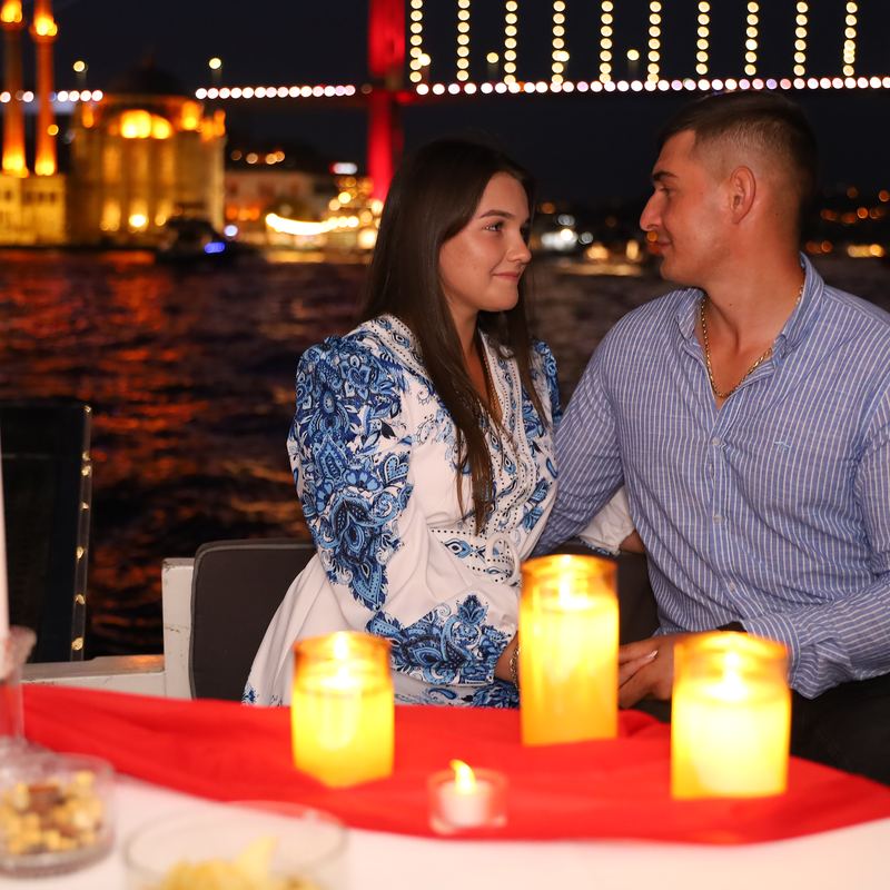 Couple by candlelight in front of Ortaköy Mosque and the Bosphorus Bridge